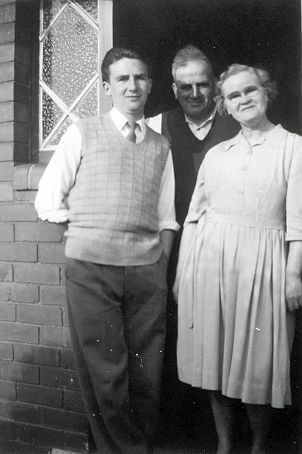 Kenneth Claybrough with his parents Albert and Elsie<br>Standing outside their house (circa 1956)